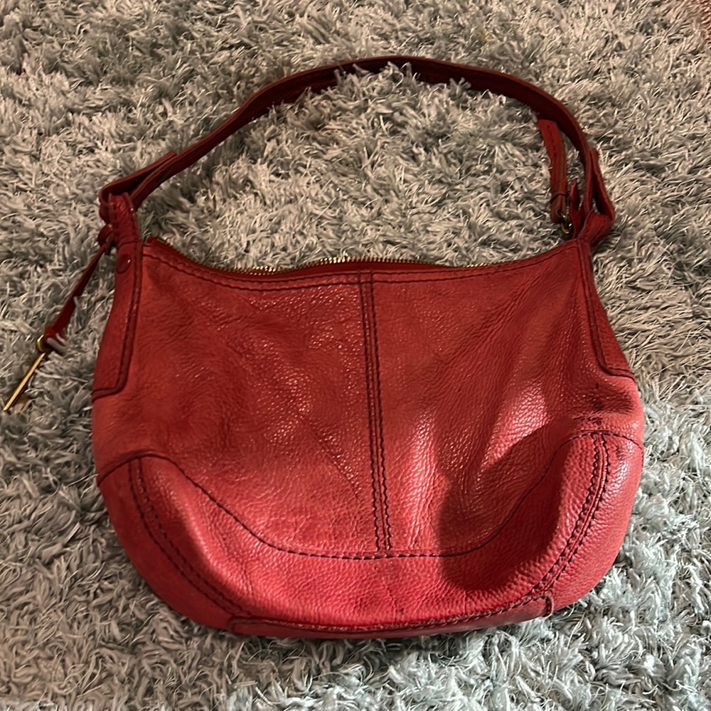 This a red Fossil purse